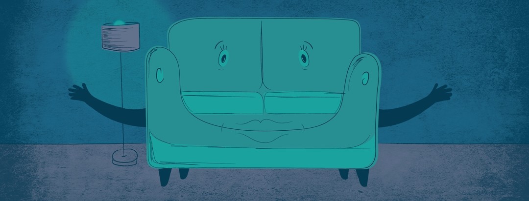 a comfy couch in a calm and dimly lit room welcoming you to it with open arms
