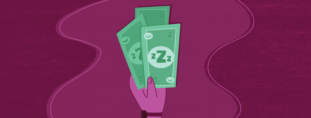 a hand holds three dollar bills which have sleep imagery on them such as Zs, moons, and stars