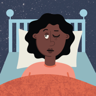 a woman in bed with one eye open and one eye closed