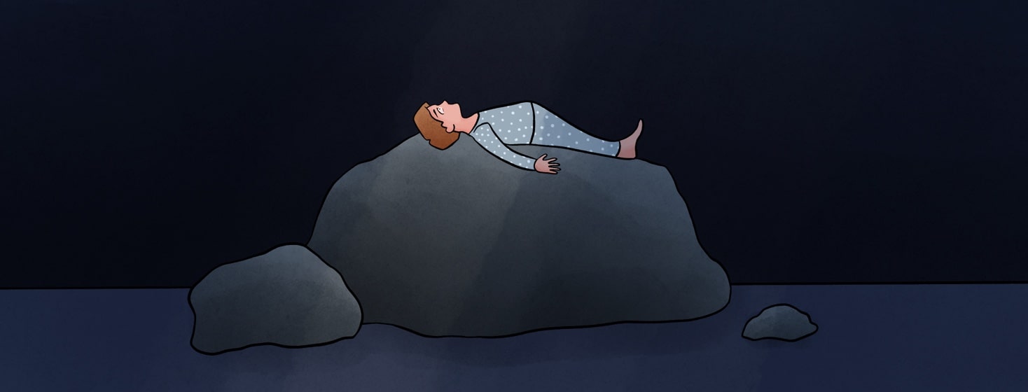 a person trying to sleep on a giant rock