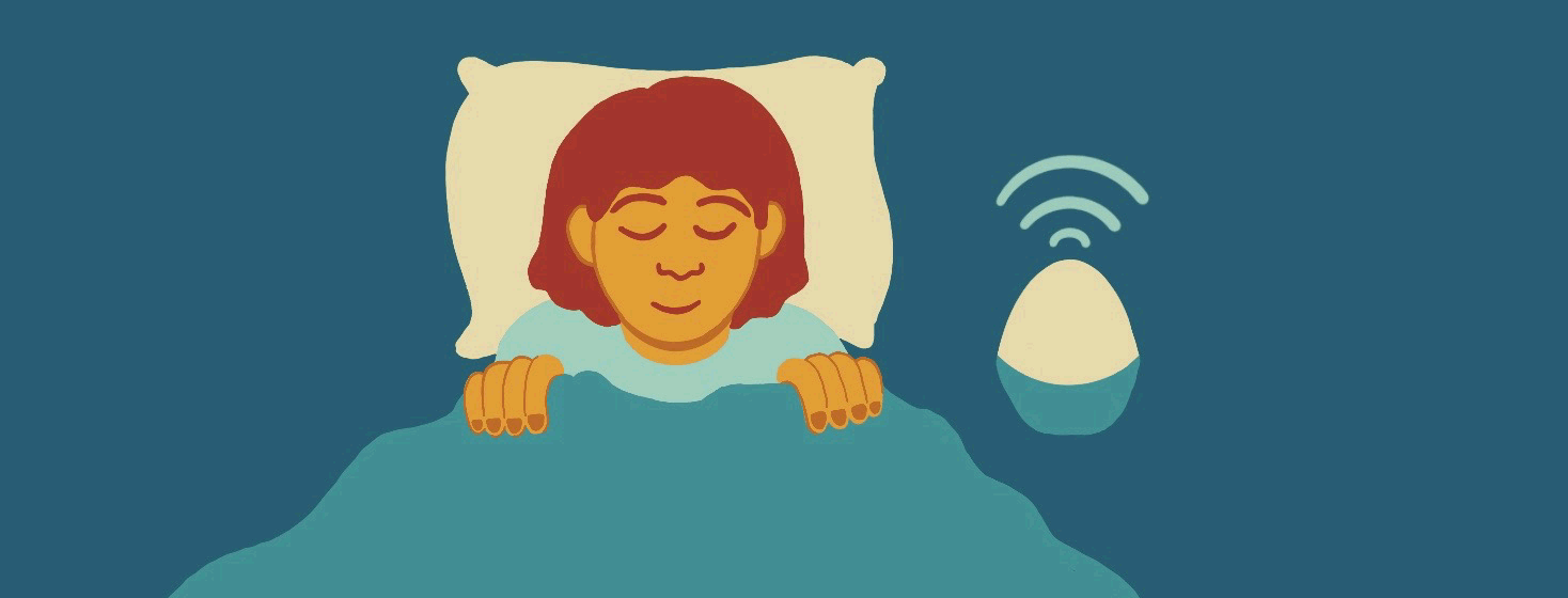 Moving image of a woman sleeping in bed to the sound of her white noise machine, then jolting awake suddenly when the noisemaker dies.