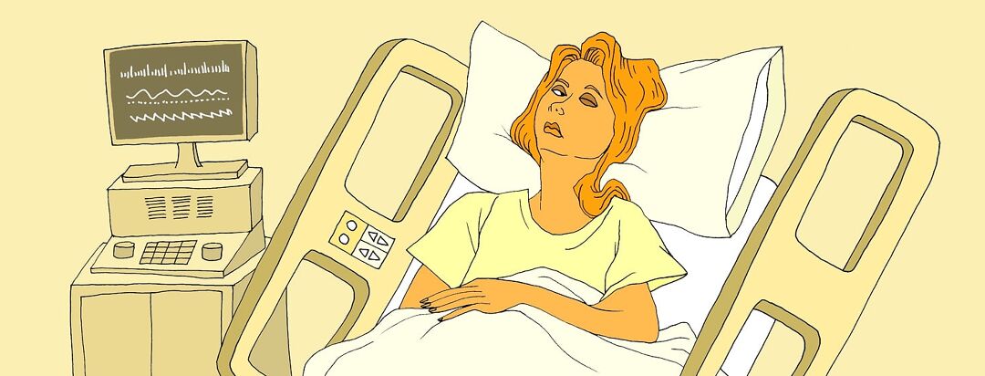 A woman lying in a hospital bed with one eye closed and one eye open