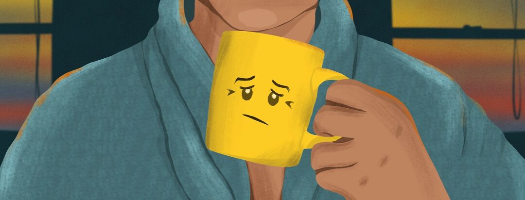 Person in a robe drinking out of a sad-faced mug